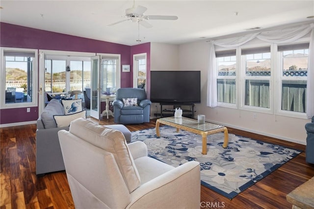 living room with dark hardwood / wood-style flooring, plenty of natural light, and ceiling fan