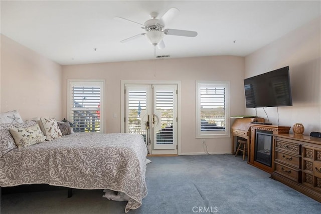 carpeted bedroom with access to outside, vaulted ceiling, multiple windows, and ceiling fan