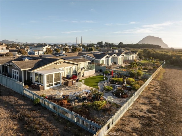 rear view of house with a mountain view, a patio, and a sunroom