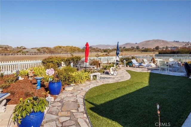 view of yard featuring a mountain view and a patio