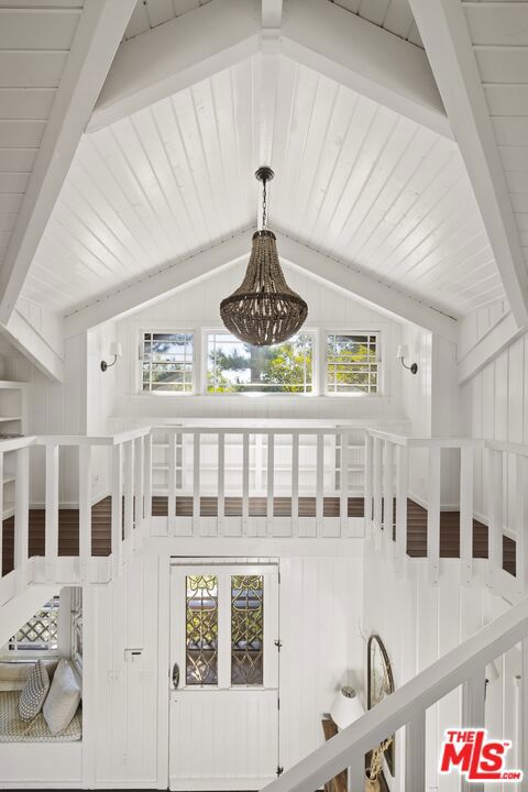 details with beam ceiling, an inviting chandelier, and wooden ceiling