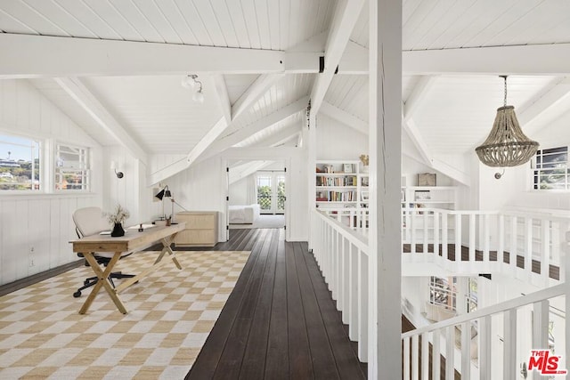 interior space featuring hardwood / wood-style floors, lofted ceiling with beams, and plenty of natural light