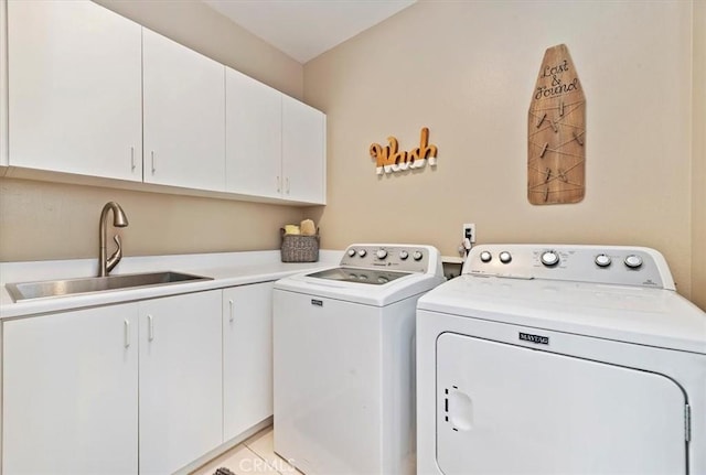 clothes washing area with sink, light tile patterned flooring, cabinets, and independent washer and dryer