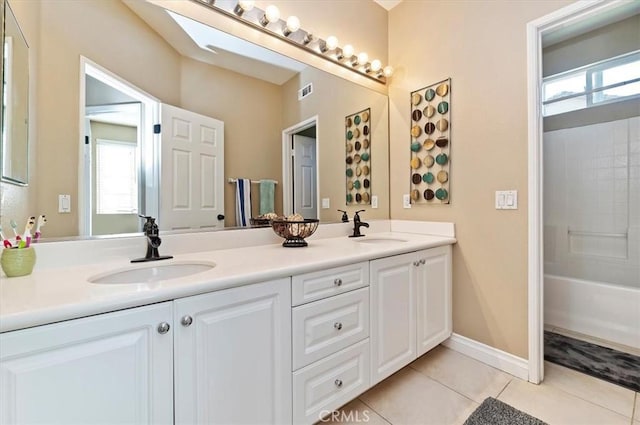 bathroom featuring tile patterned floors, vanity, a healthy amount of sunlight, and bathtub / shower combination