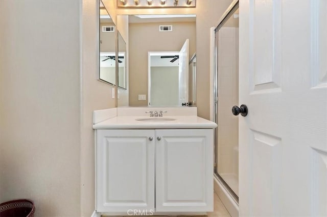 bathroom with ceiling fan, vanity, and an enclosed shower