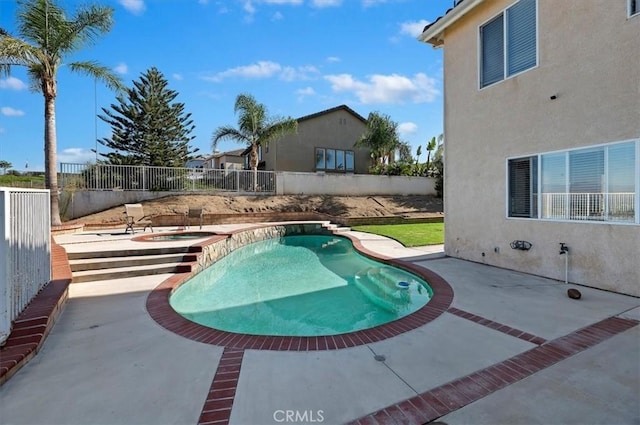 view of swimming pool with an in ground hot tub and a patio