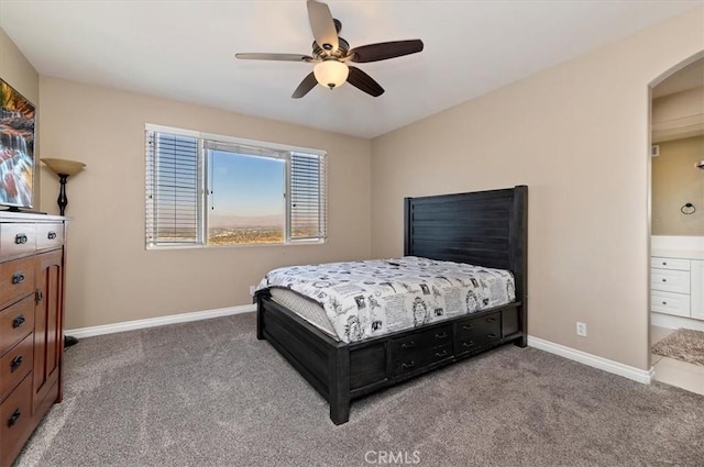 bedroom with carpet flooring, ensuite bath, and ceiling fan