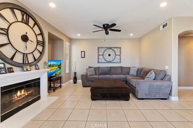 tiled living room with ceiling fan