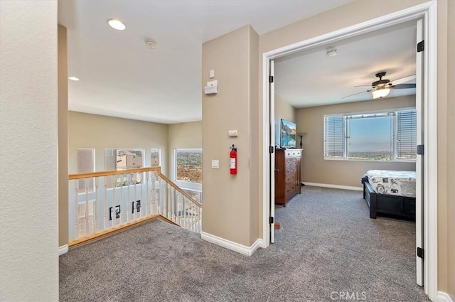 hallway featuring carpet and plenty of natural light