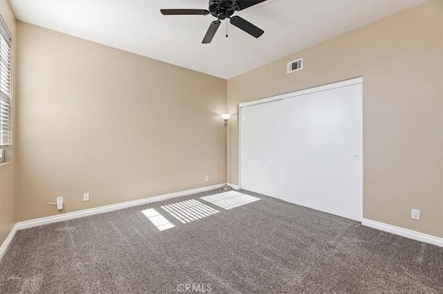 empty room featuring ceiling fan, carpet, and lofted ceiling