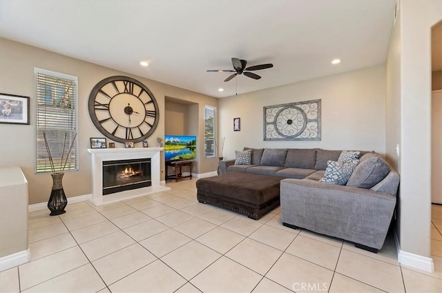 living room featuring ceiling fan and light tile patterned floors