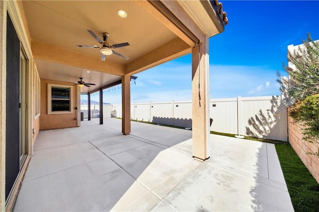 view of patio / terrace with ceiling fan and a water view