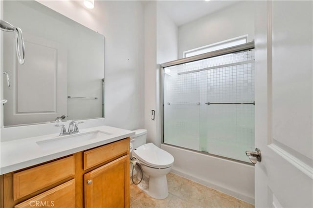 full bathroom featuring tile patterned floors, vanity, toilet, and bath / shower combo with glass door