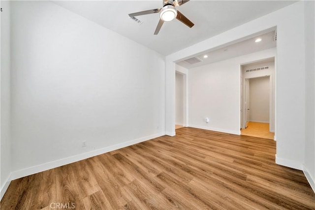 spare room with ceiling fan and light hardwood / wood-style floors