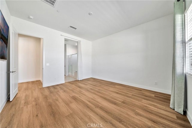 unfurnished bedroom with light wood-type flooring