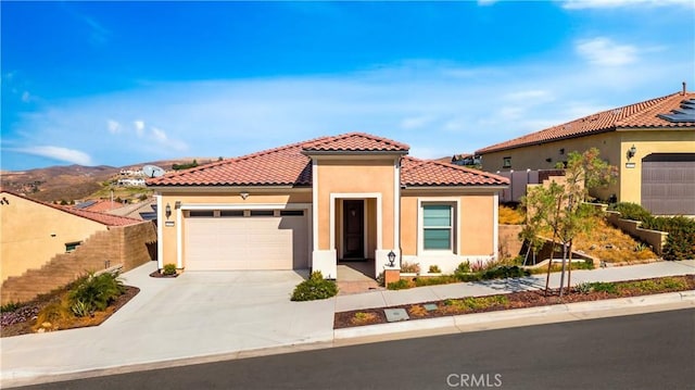 mediterranean / spanish-style house featuring a mountain view and a garage