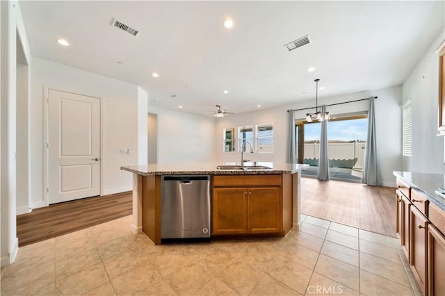 kitchen with dishwasher, an island with sink, ceiling fan with notable chandelier, and sink