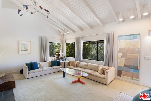 living room with beamed ceiling, light colored carpet, high vaulted ceiling, and a wealth of natural light