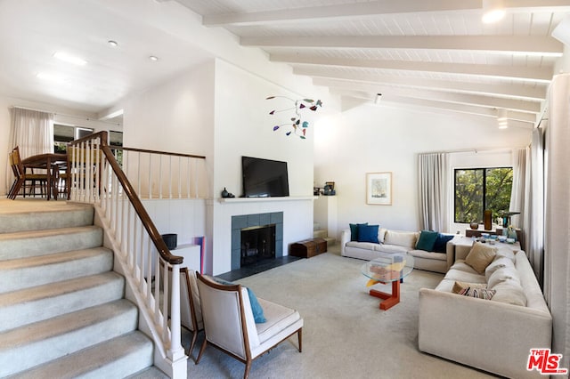 living room with beamed ceiling, high vaulted ceiling, a fireplace, and carpet