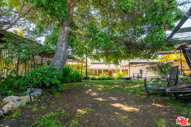 view of yard with a fire pit