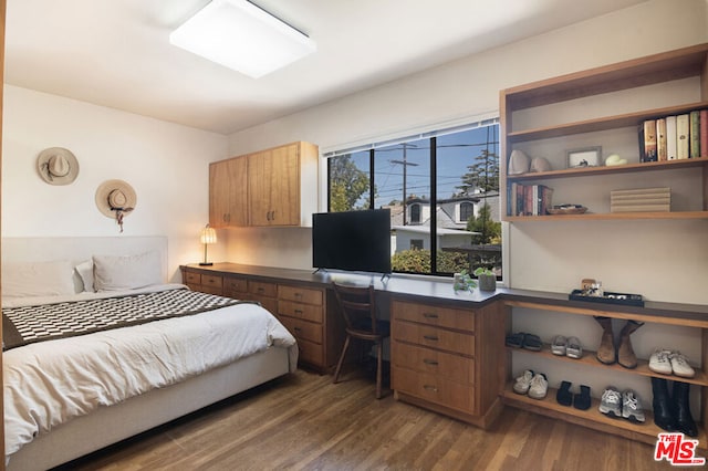 bedroom with dark hardwood / wood-style floors