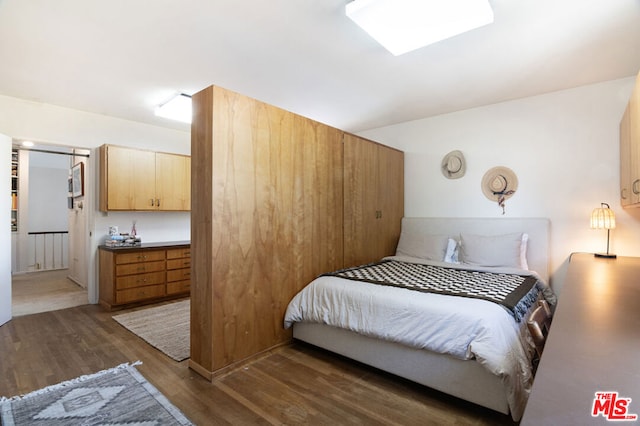 bedroom featuring dark hardwood / wood-style flooring