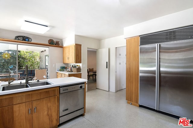 kitchen with sink and appliances with stainless steel finishes