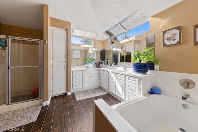 bathroom with hardwood / wood-style floors, vanity, vaulted ceiling, and independent shower and bath