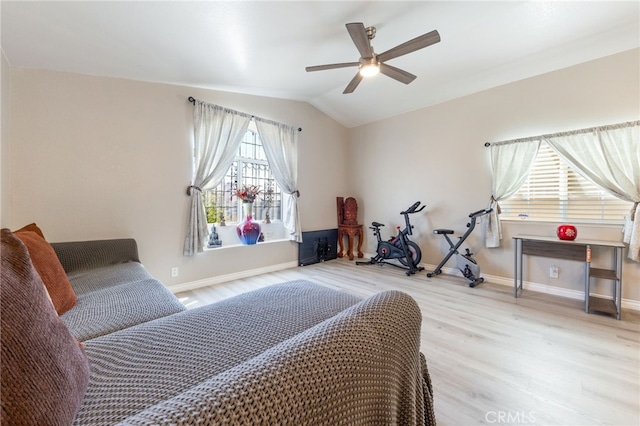 bedroom with ceiling fan, light wood-type flooring, and lofted ceiling