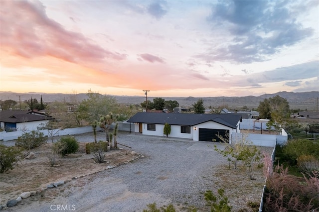 view of front facade with a mountain view and a garage