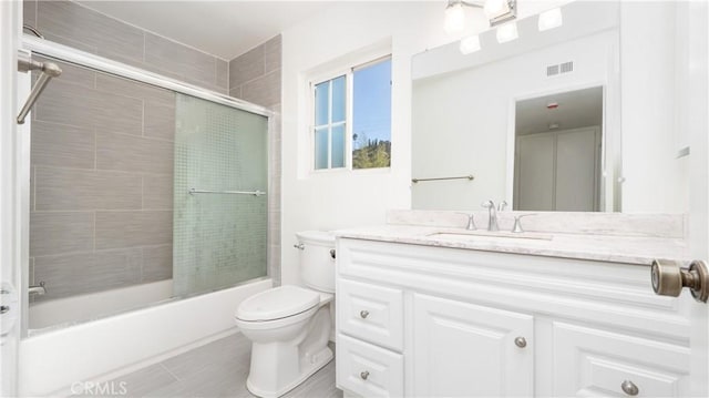 full bathroom with vanity, toilet, and shower / bath combination with glass door