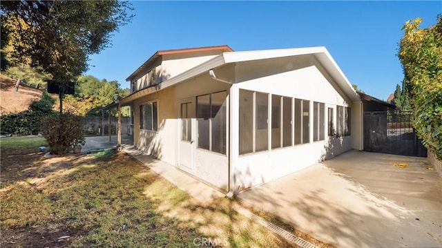 view of side of property with a patio area