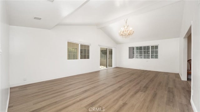 unfurnished living room with hardwood / wood-style floors, lofted ceiling with beams, and a chandelier