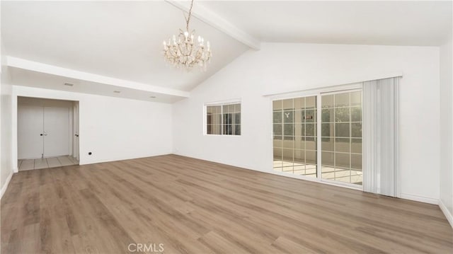 unfurnished room with hardwood / wood-style flooring, vaulted ceiling with beams, and an inviting chandelier