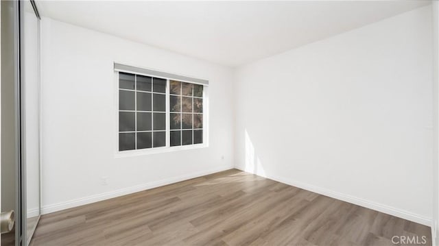 spare room featuring wood-type flooring