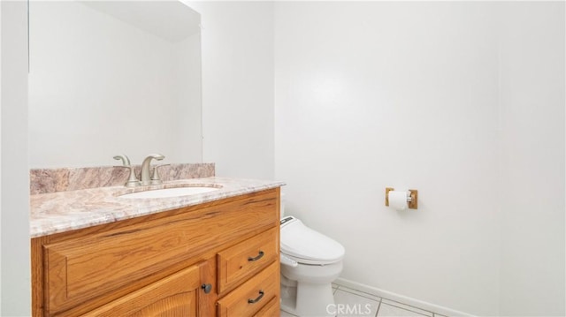 bathroom featuring tile patterned floors, vanity, and toilet