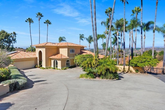 mediterranean / spanish home featuring a garage