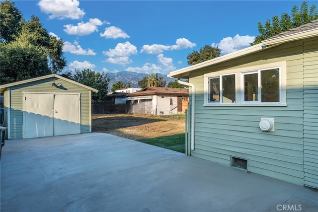 view of patio featuring a mountain view and a storage shed