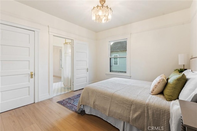 bedroom featuring hardwood / wood-style floors and a notable chandelier