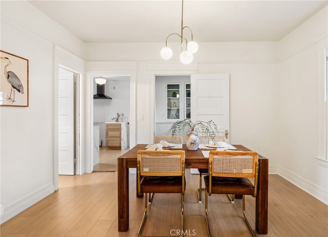 dining room featuring light hardwood / wood-style floors and a chandelier