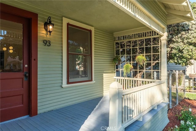 view of exterior entry featuring covered porch