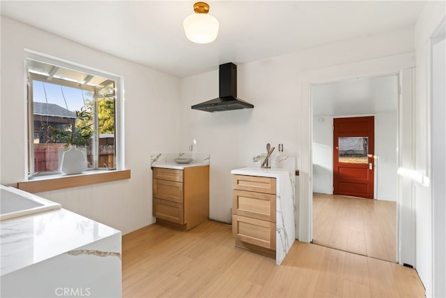 kitchen with exhaust hood and light hardwood / wood-style floors