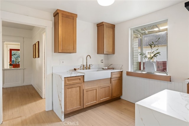 kitchen with light hardwood / wood-style floors and sink