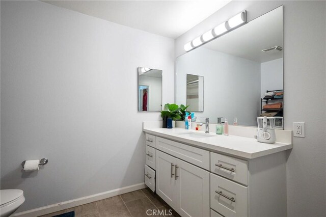 bathroom with tile patterned floors, vanity, and toilet