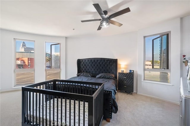 bedroom with light carpet and ceiling fan