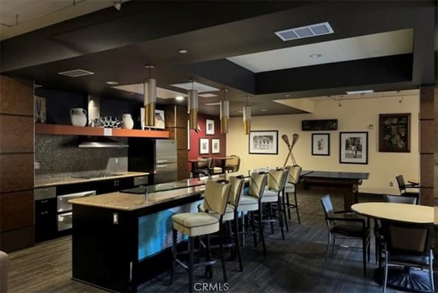 bar featuring light stone countertops, dark colored carpet, tasteful backsplash, range hood, and black electric cooktop