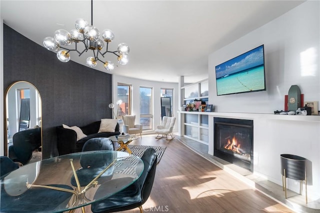 dining space with hardwood / wood-style flooring and a notable chandelier