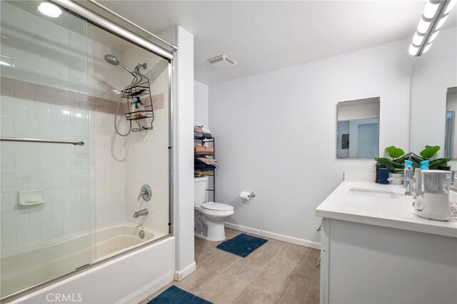 full bathroom featuring hardwood / wood-style floors, vanity, toilet, and shower / bath combination with glass door