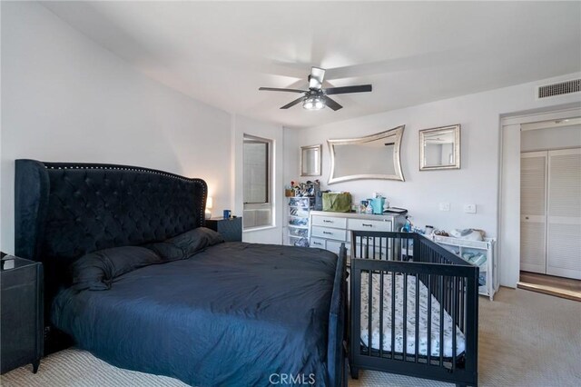 bedroom featuring ceiling fan and light colored carpet