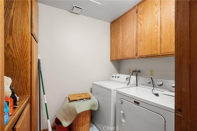 clothes washing area with light tile patterned floors, cabinets, and independent washer and dryer